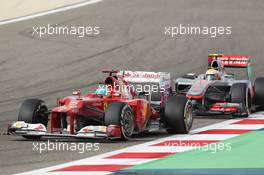 Fernando Alonso (ESP) Ferrari F2012 leads Lewis Hamilton (GBR) McLaren MP4/27. Motor Racing - Formula One World Championship - Bahrain Grand Prix - Race Day - Sakhir, Bahrain