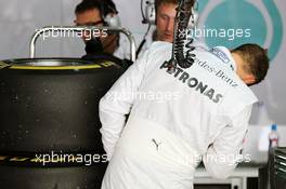 Michael Schumacher (GER) Mercedes AMG F1 takes a look at his worn Pirelli tyres. 21.04.2012. Formula 1 World Championship, Rd 4, Bahrain Grand Prix, Sakhir, Bahrain, Qualifying Day