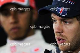 Pole sitter Sebastian Vettel (GER) Red Bull Racing in the FIA Press Conference with Lewis Hamilton (GBR) McLaren. 21.04.2012. Formula 1 World Championship, Rd 4, Bahrain Grand Prix, Sakhir, Bahrain, Qualifying Day