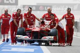 Ferrari F2012 pushed down the pit lane. 21.04.2012. Formula 1 World Championship, Rd 4, Bahrain Grand Prix, Sakhir, Bahrain, Qualifying Day