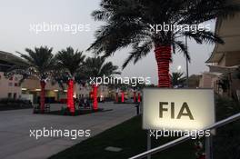 FIA building sign glowing in the paddock as dusk falls. 19.04.2012. Formula 1 World Championship, Rd 4, Bahrain Grand Prix, Sakhir, Bahrain, Preparation Day