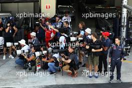 Photographers in the pit lane and Stefano Domenicali (ITA) Ferrari General Director. 23.11.2012. Formula 1 World Championship, Rd 20, Brazilian Grand Prix, Sao Paulo, Brazil, Practice Day.