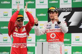 Race winner Jenson Button (GBR) McLaren celebrates on the podium with second placed Fernando Alonso (ESP) Ferrari. 25.11.2012. Formula 1 World Championship, Rd 20, Brazilian Grand Prix, Sao Paulo, Brazil, Race Day.