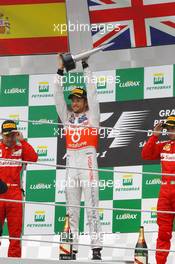 The podium (L to R): Fernando Alonso (ESP) Ferrari, second; Jenson Button (GBR) McLaren, race winner; Fernando Alonso (ESP) Ferrari, third. 25.11.2012. Formula 1 World Championship, Rd 20, Brazilian Grand Prix, Sao Paulo, Brazil, Race Day.