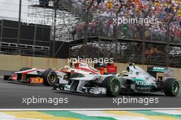 Nico Rosberg (GER) Mercedes AMG F1 W03 and Narain Karthikeyan (IND) HRT Formula One Team HRT F112. 25.11.2012. Formula 1 World Championship, Rd 20, Brazilian Grand Prix, Sao Paulo, Brazil, Race Day.