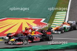 Mark Webber (AUS) Red Bull Racing RB8, Fernando Alonso (ESP) Ferrari F2012 and Nico Hulkenberg (GER) Sahara Force India F1 VJM05 at the start of the race. 25.11.2012. Formula 1 World Championship, Rd 20, Brazilian Grand Prix, Sao Paulo, Brazil, Race Day.