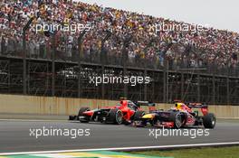 Sebastian Vettel (GER) Red Bull Racing RB8 passes Charles Pic (FRA) Marussia F1 Team MR01. 25.11.2012. Formula 1 World Championship, Rd 20, Brazilian Grand Prix, Sao Paulo, Brazil, Race Day.