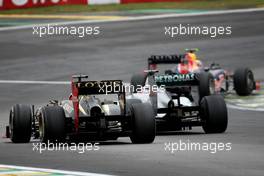 Kimi Raikkonen (FIN), Lotus F1 Team and Michael Schumacher (GER), Mercedes GP  25.11.2012. Formula 1 World Championship, Rd 20, Brazilian Grand Prix, Sao Paulo, BRA, Race Day