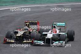 Michael Schumacher (GER) Mercedes AMG F1 W03 and Kimi Raikkonen (FIN) Lotus F1 E20 battle for position. 25.11.2012. Formula 1 World Championship, Rd 20, Brazilian Grand Prix, Sao Paulo, Brazil, Race Day.