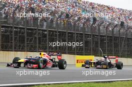 Sebastian Vettel (GER) Red Bull Racing RB8 leads Jean-Eric Vergne (FRA) Scuderia Toro Rosso STR7. 25.11.2012. Formula 1 World Championship, Rd 20, Brazilian Grand Prix, Sao Paulo, Brazil, Race Day.