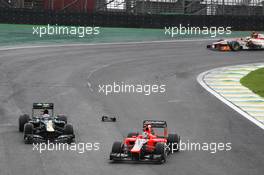 Timo Glock (GER) Marussia F1 Team MR01 and Vitaly Petrov (RUS) Caterham CT01. 25.11.2012. Formula 1 World Championship, Rd 20, Brazilian Grand Prix, Sao Paulo, Brazil, Race Day.