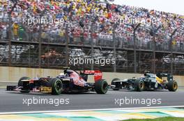 Jean-Eric Vergne (FRA) Scuderia Toro Rosso STR7 leads Vitaly Petrov (RUS) Caterham CT01. 25.11.2012. Formula 1 World Championship, Rd 20, Brazilian Grand Prix, Sao Paulo, Brazil, Race Day.