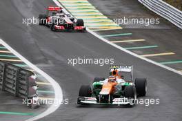 Nico Hulkenberg (GER) Sahara Force India F1 VJM05 leads Jenson Button (GBR) McLaren MP4/27 out of the pits. 25.11.2012. Formula 1 World Championship, Rd 20, Brazilian Grand Prix, Sao Paulo, Brazil, Race Day.