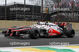 Jenson Button (GBR) McLaren MP4/27 and Lewis Hamilton (GBR) McLaren MP4/27 battle for position. 25.11.2012. Formula 1 World Championship, Rd 20, Brazilian Grand Prix, Sao Paulo, Brazil, Race Day.