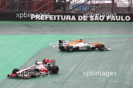 Nico Hulkenberg (GER) Sahara Force India F1 VJM05 and Lewis Hamilton (GBR) McLaren MP4/27 crash battling for the lead of the race. 25.11.2012. Formula 1 World Championship, Rd 20, Brazilian Grand Prix, Sao Paulo, Brazil, Race Day.