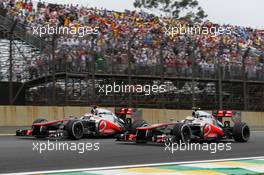 Jenson Button (GBR) McLaren MP4/27 and team mate Lewis Hamilton (GBR) McLaren MP4/27. 25.11.2012. Formula 1 World Championship, Rd 20, Brazilian Grand Prix, Sao Paulo, Brazil, Race Day.