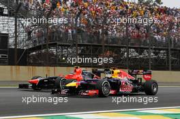 Sebastian Vettel (GER) Red Bull Racing RB8 passes Charles Pic (FRA) Marussia F1 Team MR01. 25.11.2012. Formula 1 World Championship, Rd 20, Brazilian Grand Prix, Sao Paulo, Brazil, Race Day.