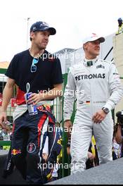 (L to R): Sebastian Vettel (GER) Red Bull Racing and Michael Schumacher (GER) Mercedes AMG F1 on the drivers parade. 25.11.2012. Formula 1 World Championship, Rd 20, Brazilian Grand Prix, Sao Paulo, Brazil, Race Day.