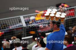 Sebastian Vettel (GER) Red Bull Racing RB8 passes a beer seller in the grandstand. 08.06.2012. Formula 1 World Championship, Rd 7, Canadian Grand Prix, Montreal, Canada, Practice Day