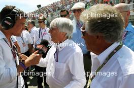 (L to R): Will Buxton (GBR) Speed TV Presenter with Bernie Ecclestone (GBR) CEO Formula One Group (FOM) and Mario Andretti (USA) on the grid. 10.06.2012. Formula 1 World Championship, Rd 7, Canadian Grand Prix, Montreal, Canada, Race Day