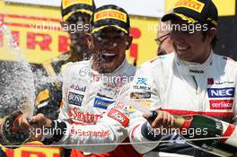 Race winner Lewis Hamilton (GBR) McLaren celebrates on the podium with Sergio Perez (MEX) Sauber. 10.06.2012. Formula 1 World Championship, Rd 7, Canadian Grand Prix, Montreal, Canada, Race Day