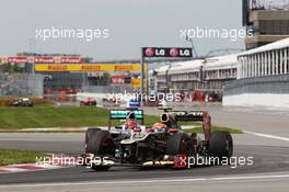 Romain Grosjean (FRA) Lotus F1 E20 leads Michael Schumacher (GER) Mercedes AMG F1 W03. 10.06.2012. Formula 1 World Championship, Rd 7, Canadian Grand Prix, Montreal, Canada, Race Day
