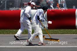 Marshalls sweep debris from the track. 09.06.2012. Formula 1 World Championship, Rd 7, Canadian Grand Prix, Montreal, Canada, Qualifying Day
