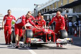 The Ferrari F2012 of Felipe Massa (BRA) Ferrari is pushed along the pit lane. 09.06.2012. Formula 1 World Championship, Rd 7, Canadian Grand Prix, Montreal, Canada, Qualifying Day