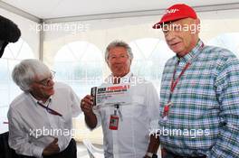 Mario Andretti (USA) (Centre) presenting a VIP ticket for the 2012 United States Grand Prix to Bernie Ecclestone (GBR) CEO Formula One Group (FOM) (Left) and Niki Lauda (AUT) (Right). 10.06.2012. Formula 1 World Championship, Rd 7, Canadian Grand Prix, Montreal, Canada, Race Day