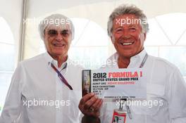 Mario Andretti (USA) (Right) presenting a VIP ticket for the 2012 United States Grand Prix to Bernie Ecclestone (GBR) CEO Formula One Group (FOM) (Left). Canadian Grand Prix, Sunday 10th June 2012. Montreal, Canada. 10.06.2012. Formula 1 World Championship, Rd 7, Canadian Grand Prix, Montreal, Canada, Race Day