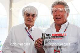 Mario Andretti (USA) (Centre) presenting a VIP ticket for the 2012 United States Grand Prix to Bernie Ecclestone (GBR) CEO Formula One Group (FOM) (Left). 10.06.2012. Formula 1 World Championship, Rd 7, Canadian Grand Prix, Montreal, Canada, Race Day