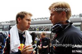 (L to R): Sebastian Vettel (GER) Red Bull Racing with Heikki Huovinen (FIN) Personal Trainer. 15.04.2012. Formula 1 World Championship, Rd 3, Chinese Grand Prix, Shanghai, China, Race Day