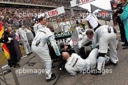 Mercedes AMG F1 W03 of pole sitter and race winner Nico Rosberg (GER) Mercedes AMG F1 worked on the grid by mechanics. 15.04.2012. Formula 1 World Championship, Rd 3, Chinese Grand Prix, Shanghai, China, Race Day