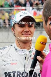 Race winner Nico Rosberg (GER) Mercedes AMG F1 with Kai Ebel (GER) RTL TV Presenter on the grid. 15.04.2012. Formula 1 World Championship, Rd 3, Chinese Grand Prix, Shanghai, China, Race Day