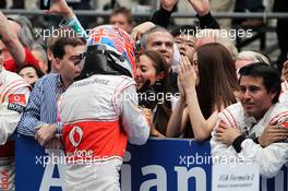 Jenson Button (GBR) McLaren celebrates his second position in parc ferme with girlfriend Jessica Michibata (JPN) and her sister Angelica Michibata (JPN). 15.04.2012. Formula 1 World Championship, Rd 3, Chinese Grand Prix, Shanghai, China, Race Day