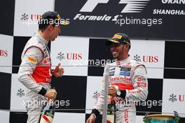 (L to R): second placed Jenson Button (GBR) McLaren with third placed team mate Lewis Hamilton (GBR) McLaren on the podium. 15.04.2012. Formula 1 World Championship, Rd 3, Chinese Grand Prix, Shanghai, China, Race Day