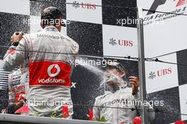 (L to R): Jenson Button (GBR) McLaren celebrates his second position with the champagne on the podium with race winner Nico Rosberg (GER) Mercedes AMG F1. 15.04.2012. Formula 1 World Championship, Rd 3, Chinese Grand Prix, Shanghai, China, Race Day