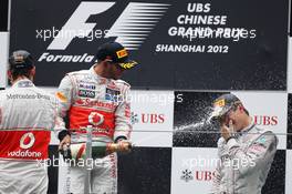 (L to R): Lewis Hamilton (GBR) McLaren celebrates with Jenson Button (GBR) McLaren on the podium. 15.04.2012. Formula 1 World Championship, Rd 3, Chinese Grand Prix, Shanghai, China, Race Day