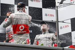 (L to R): Jenson Button (GBR) McLaren celebrates his second position on the podium with race winner Nico Rosberg (GER) Mercedes AMG F1. 15.04.2012. Formula 1 World Championship, Rd 3, Chinese Grand Prix, Shanghai, China, Race Day