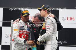 (L to R): Lewis Hamilton (GBR) McLaren with Norbert Haug (GER) Mercedes Sporting Director and race winner Nico Rosberg (GER) Mercedes AMG F1 on the podium. 15.04.2012. Formula 1 World Championship, Rd 3, Chinese Grand Prix, Shanghai, China, Race Day