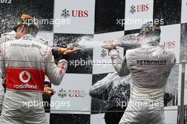 The podium (L to R): second placed Jenson Button (GBR) McLaren Jenson Button (GBR) McLaren celebrates the champagne with race winner Nico Rosberg (GER) Mercedes AMG F1. 15.04.2012. Formula 1 World Championship, Rd 3, Chinese Grand Prix, Shanghai, China, Race Day