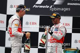 (L to R): second placed Jenson Button (GBR) McLaren with third placed team mate Lewis Hamilton (GBR) McLaren on the podium. 15.04.2012. Formula 1 World Championship, Rd 3, Chinese Grand Prix, Shanghai, China, Race Day