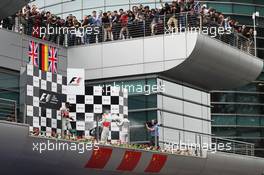 Jenson Button (GBR) McLaren celebrates on the podium with race winner Nico Rosberg (GER) Mercedes AMG F1. 15.04.2012. Formula 1 World Championship, Rd 3, Chinese Grand Prix, Shanghai, China, Race Day
