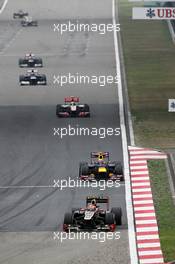 Romain Grosjean (FRA) Lotus F1 E20 leads Mark Webber (AUS) Red Bull Racing RB8. 15.04.2012. Formula 1 World Championship, Rd 3, Chinese Grand Prix, Shanghai, China, Race Day