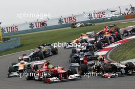 (L to R): Felipe Massa (BRA) Ferrari F2012 and Romain Grosjean (FRA) Lotus F1 E20 battle at the start of the race. 15.04.2012. Formula 1 World Championship, Rd 3, Chinese Grand Prix, Shanghai, China, Race Day