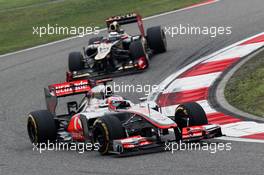 Jenson Button (GBR) McLaren MP4/27 leads Kimi Raikkonen (FIN) Lotus E20. 15.04.2012. Formula 1 World Championship, Rd 3, Chinese Grand Prix, Shanghai, China, Race Day