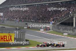 Lewis Hamilton (GBR) McLaren MP4/27  battles for position with Mark Webber (AUS) Red Bull Racing RB8 and Kimi Raikkonen (FIN) Lotus E20. 15.04.2012. Formula 1 World Championship, Rd 3, Chinese Grand Prix, Shanghai, China, Race Day