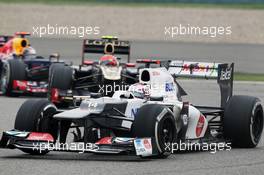 Kamui Kobayashi (JPN) Sauber C31 leads Romain Grosjean (FRA) Lotus F1 E20 and Sebastian Vettel (GER) Red Bull Racing RB8. 15.04.2012. Formula 1 World Championship, Rd 3, Chinese Grand Prix, Shanghai, China, Race Day