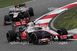 Jenson Button (GBR) McLaren MP4/27 leads Kimi Raikkonen (FIN) Lotus E20. 15.04.2012. Formula 1 World Championship, Rd 3, Chinese Grand Prix, Shanghai, China, Race Day