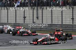 Jenson Button (GBR) McLaren MP4/27 leads Kimi Raikkonen (FIN) Lotus E20. 15.04.2012. Formula 1 World Championship, Rd 3, Chinese Grand Prix, Shanghai, China, Race Day